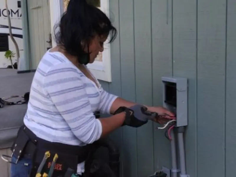 Licensed electrician wiring an exterior subpanel in Towson